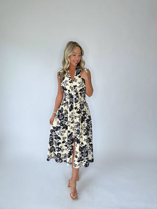 Woman wearing a floral dress against a plain background