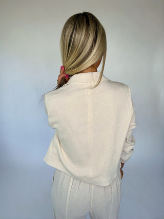 Person wearing a white outfit against a plain background