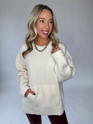 Woman wearing the Warm Embrace front pocket top in ivory