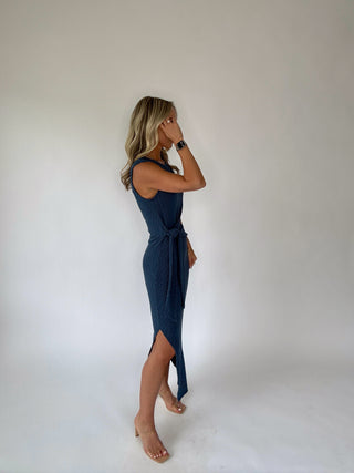 Woman wearing a blue dress against a plain background