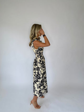 Woman wearing a floral dress against a plain background