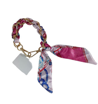 Bracelet with a patterned scarf and tag on a white background