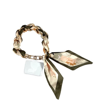 Bracelet with braided design and floral scarf on a white background
