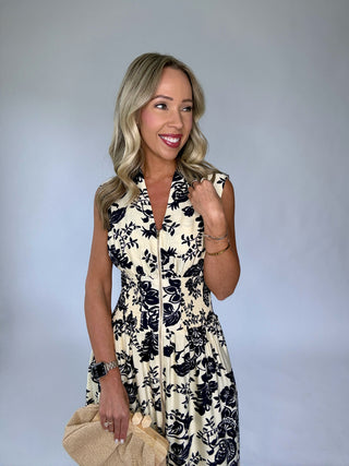 Woman wearing a floral dress against a plain background