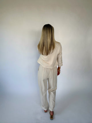 Woman wearing a beige outfit against a white background