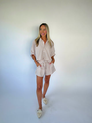 Woman wearing a striped shirt and shorts set on a white background