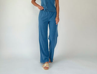Person wearing a blue set on a plain background