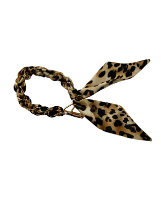 Leopard print hair tie on a white background