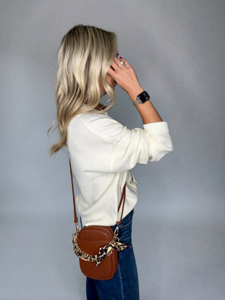 The Travel Edit Crossbody Camel Side Hand Up Image