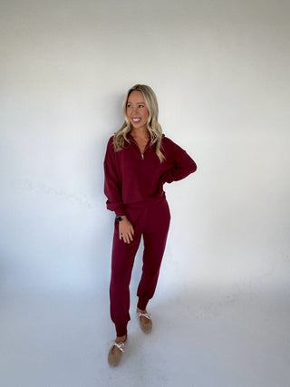 VARLEY The Slim Cuff Pant 27.5" New Maroon Full Length Hand on Hip Image