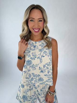 Woman wearing a floral dress with a plain background