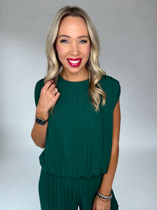 Woman wearing a green dress against a plain background